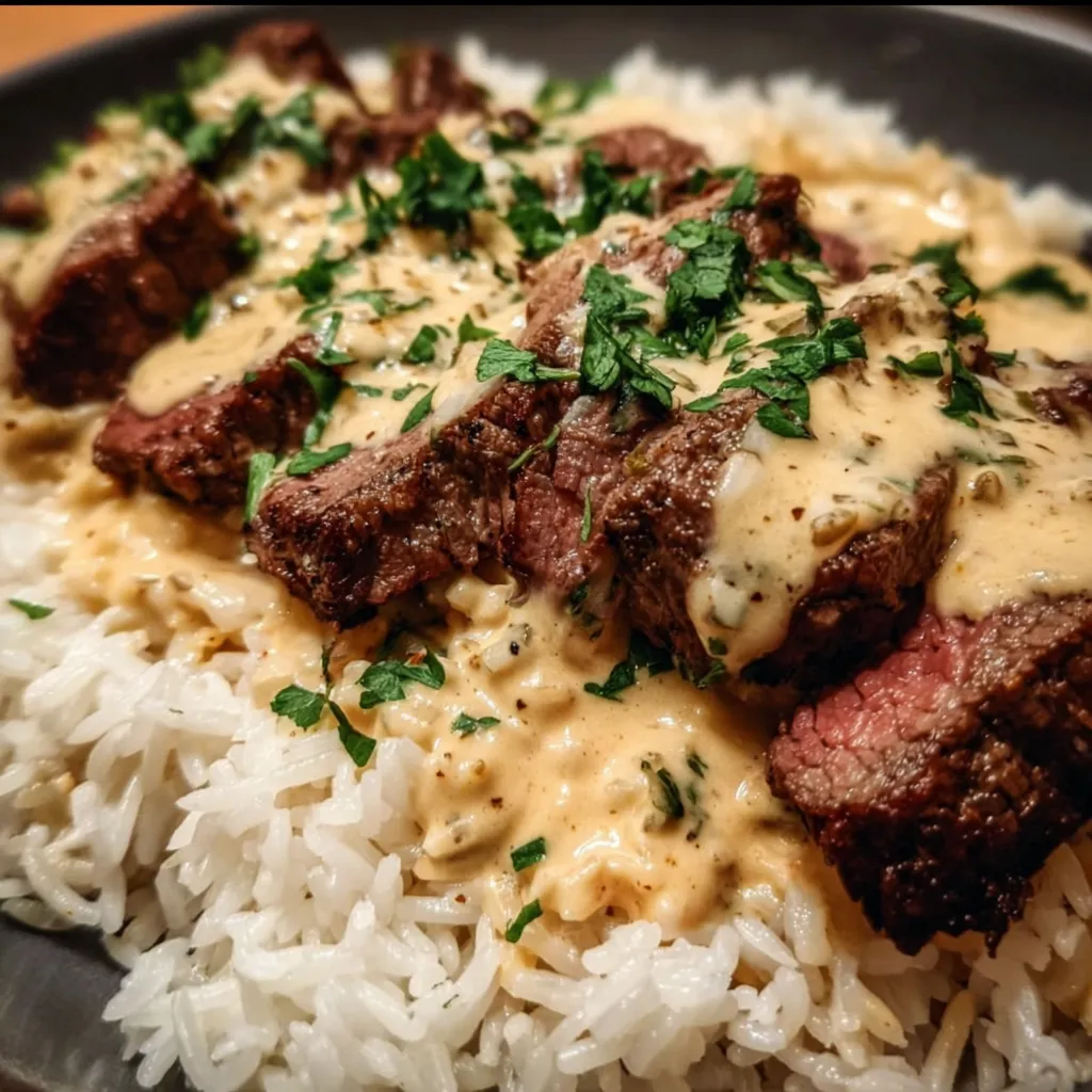 Loaded Steak Queso Rice Bowl with Creamy Cheese Sauce and Herbs